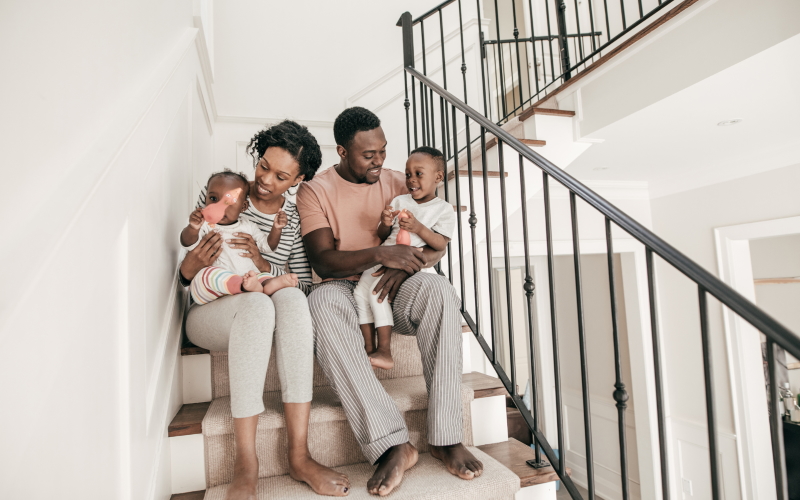 African-American family sitting on staircase steps